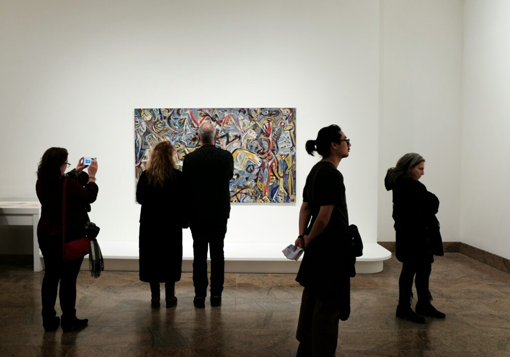 “Visitors observing an abstract painting in a contemporary art gallery.”
Photo by Jessica Pamp on Unsplash
Photo by <a href="https://unsplash.com/@yessijes?utm_source=unsplash&utm_medium=referral&utm_content=creditCopyText">Jessica Pamp</a> on <a href="https://unsplash.com/photos/a-group-of-people-standing-in-front-of-a-painting-JNTSoyb_bbw?utm_source=unsplash&utm_medium=referral&utm_content=creditCopyText">Unsplash</a>